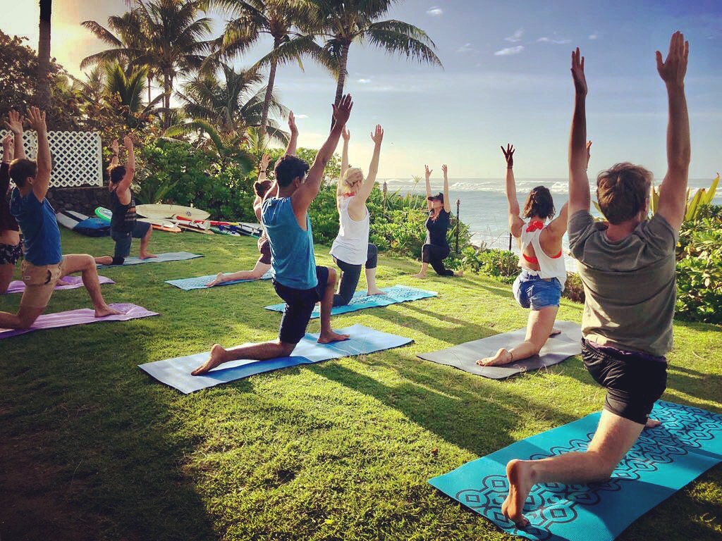 A couple and their friends practice yoga before their unique wedding ceremony in Hawaii.