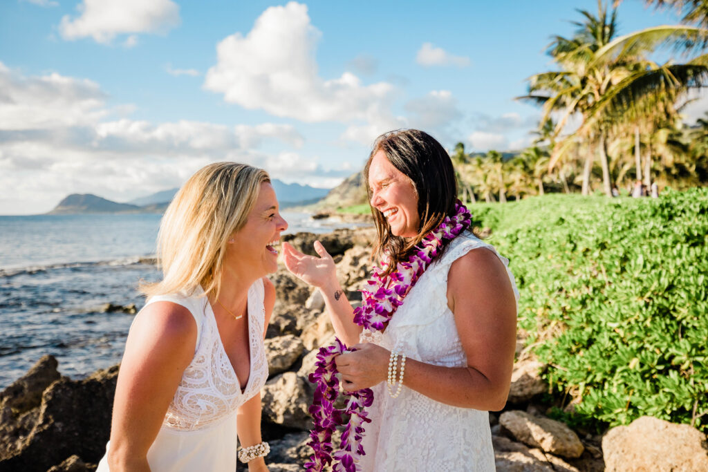 Two women have a commitment ceremony on the beach in Hawaii