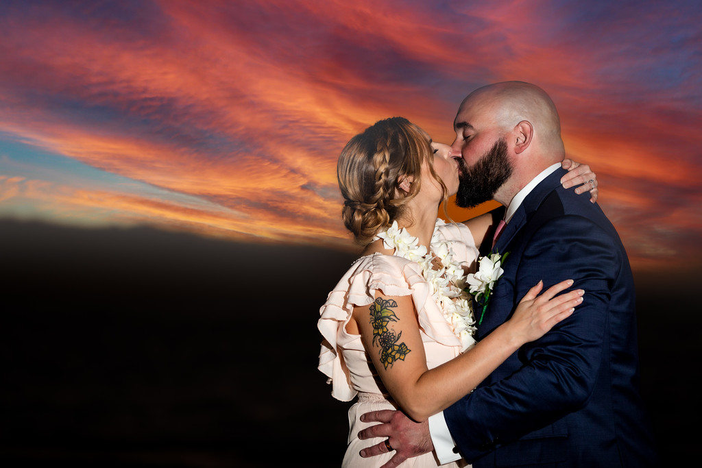 Couple has wedding in Hawaii and kisses under the sunset